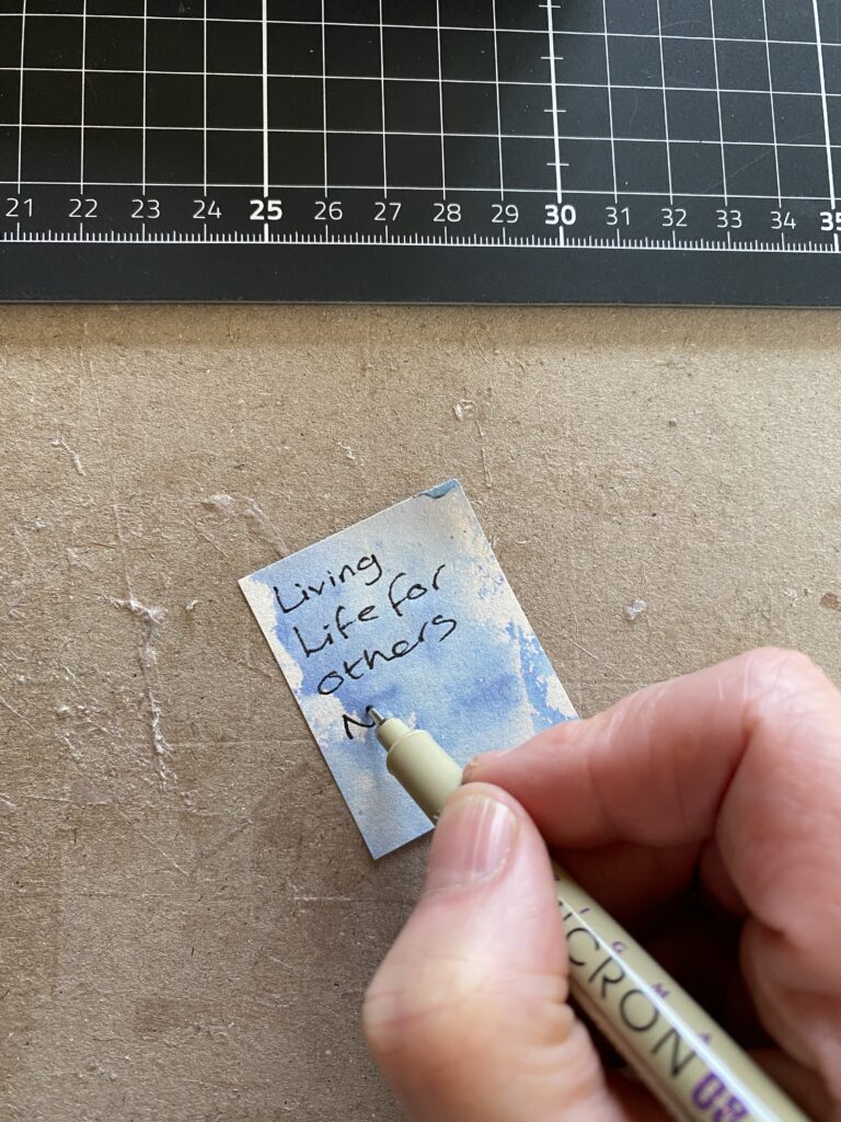 Writing boundaries on small junk journal papers to go inside Life Junk Journal spread