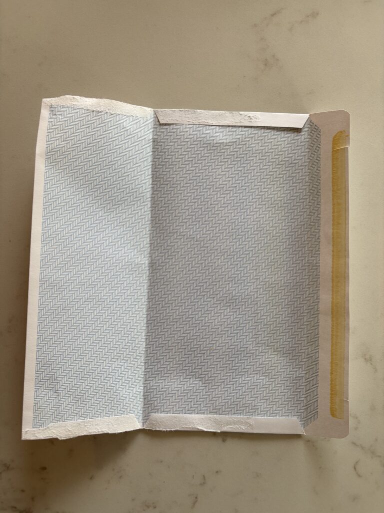 old envelope opened right up laid flat as one piece on a table