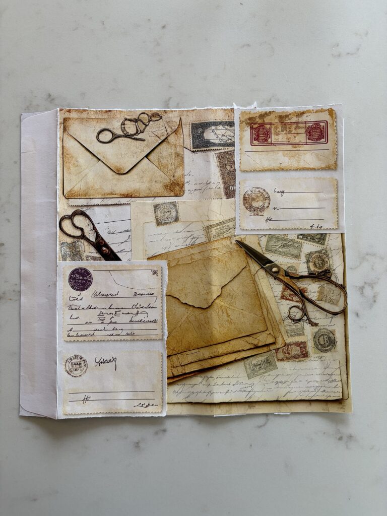 Covering the front of an old envelope with junk journal ephemera