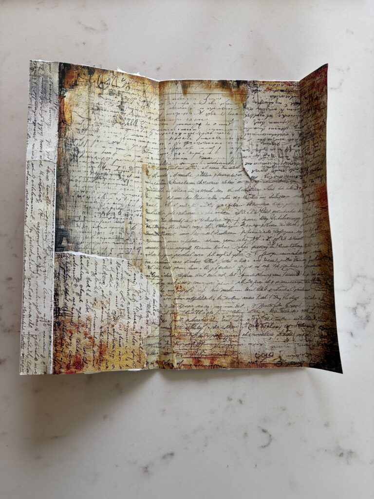 Old envelope opened up and covered inside with junk journal ephemera