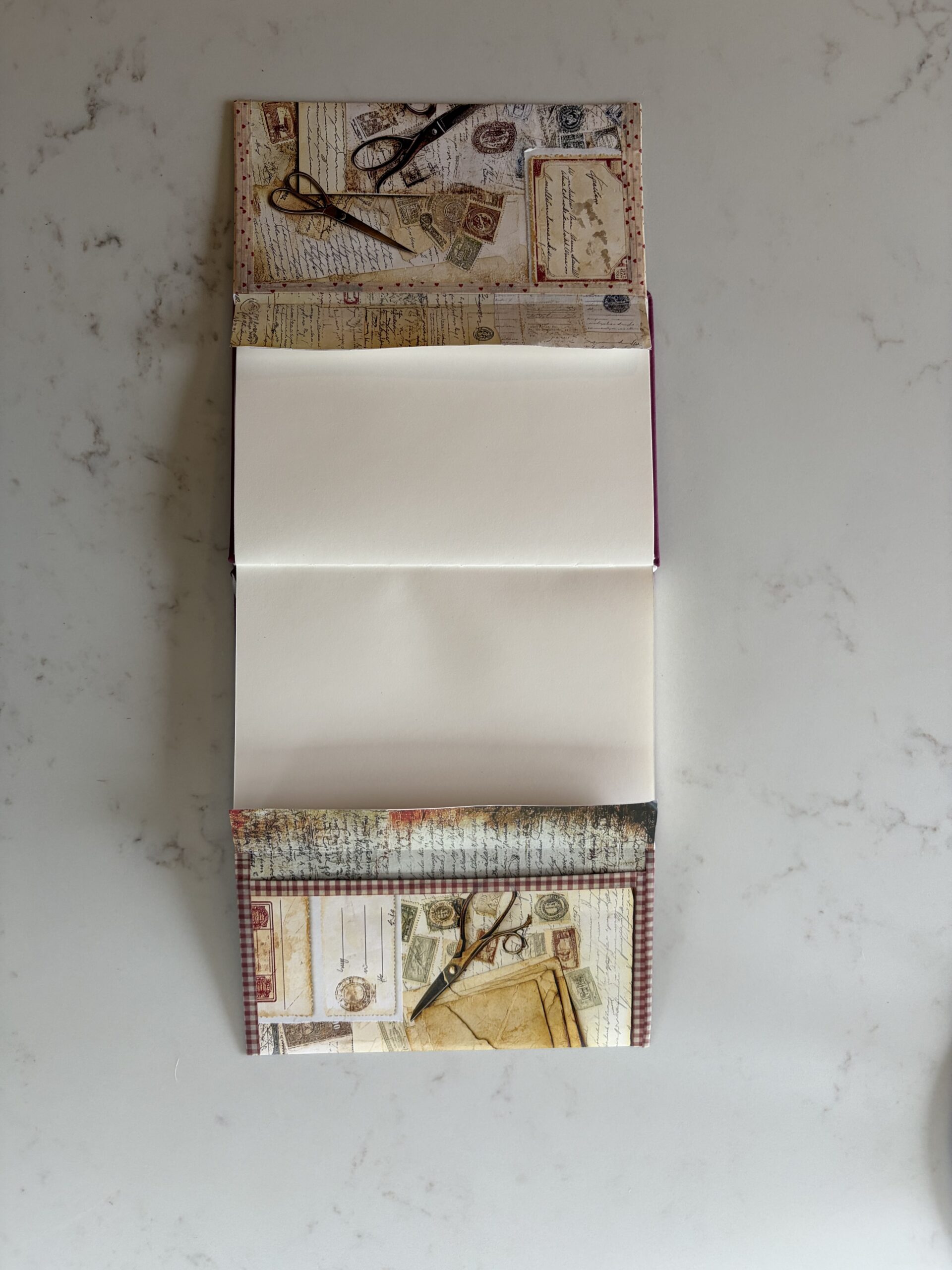 Two envelopes glued inside a junk journal opened up to show the full spread