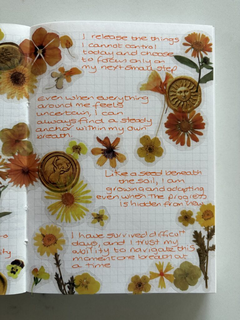 Adding stickers to a life junk journal after writing in it to finish the spread.