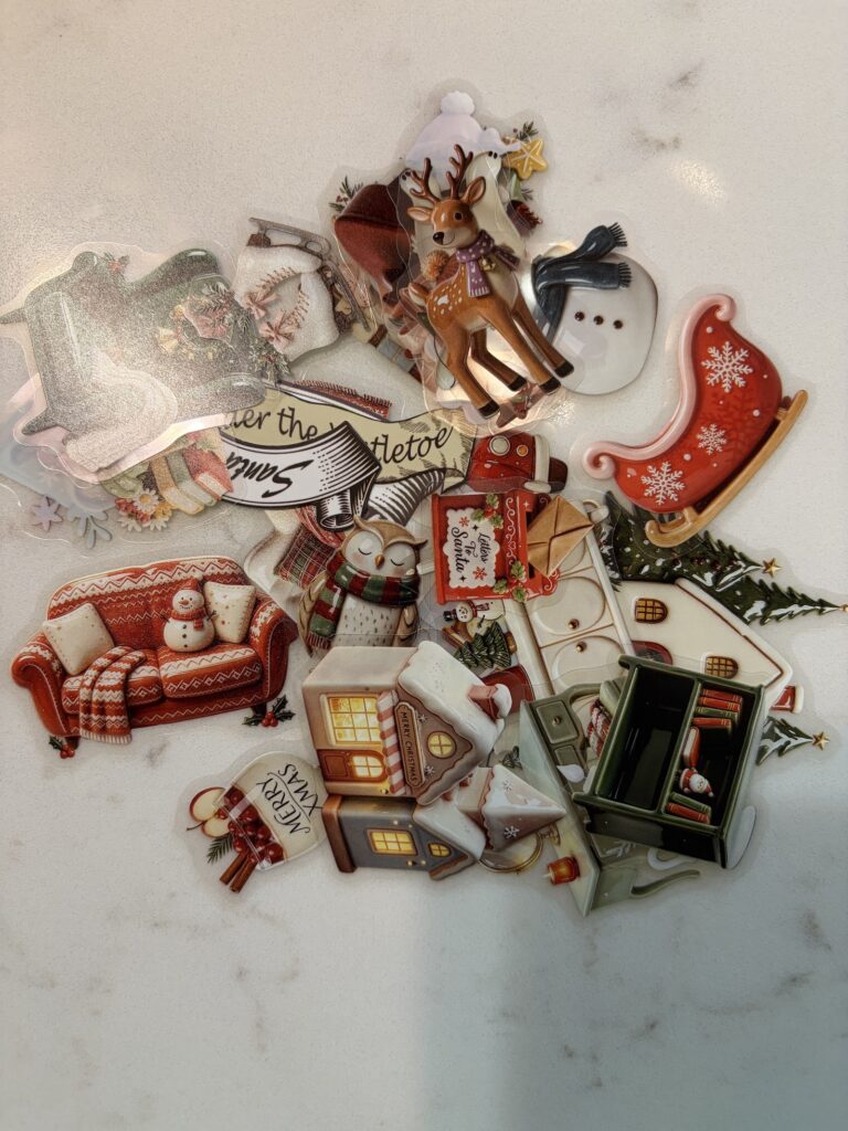 Pile of Christmas stickers for a junk journal Christmas spread.
